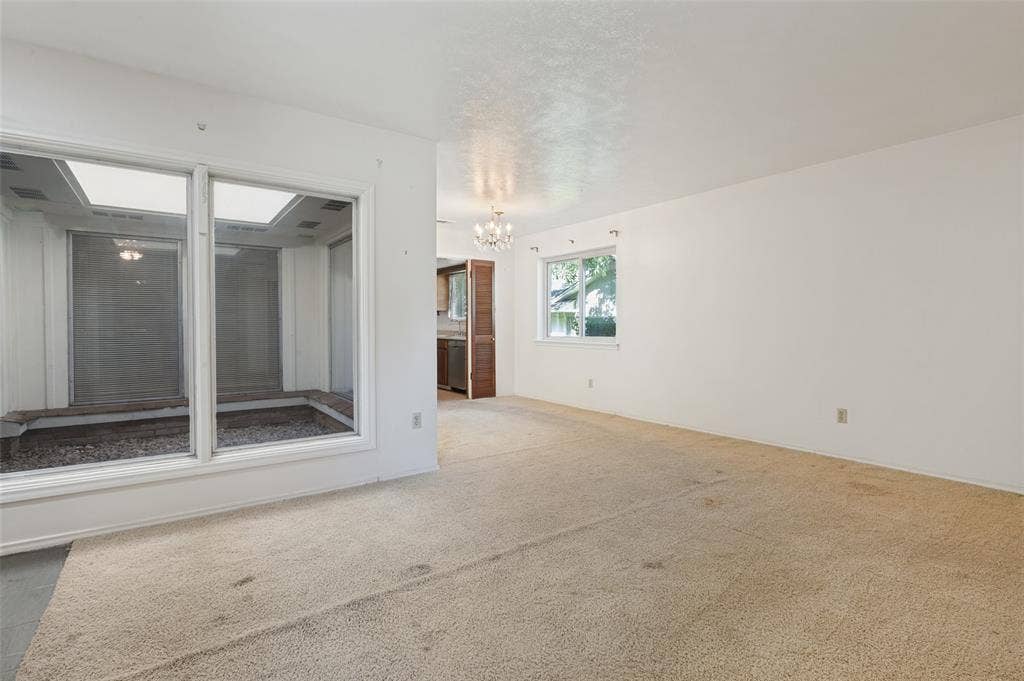 Spacious interior featuring neutral carpeting and white wall finishes