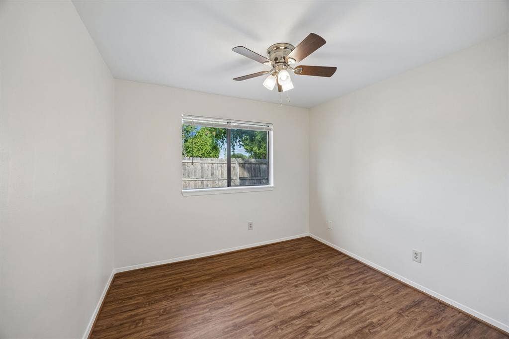 1613 19th Street, Plano, TX 75074 Tray ceiling with a ceiling fan, wood-finish flooring, and a large window