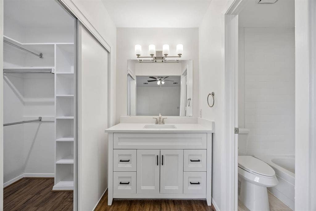 1613 19th Street, Plano, TX 75074 White shaker-style vanity with a single basin, quartz countertop, and brushed nickel faucet