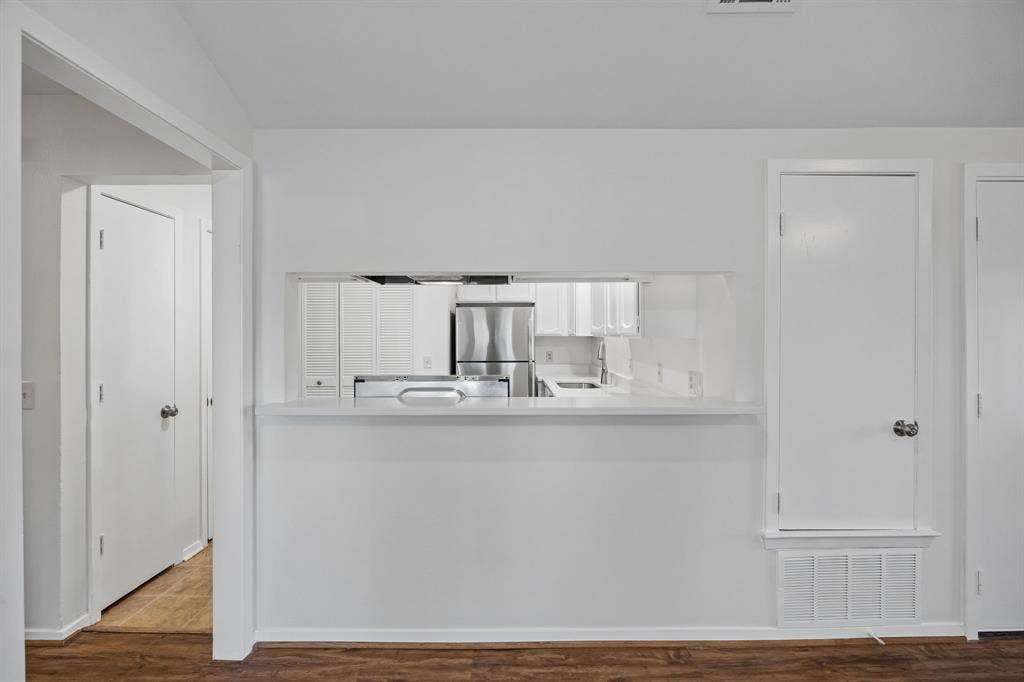 1613 19th Street, Plano, TX 75074 Kitchen pass-through with white countertop and white cabinetry