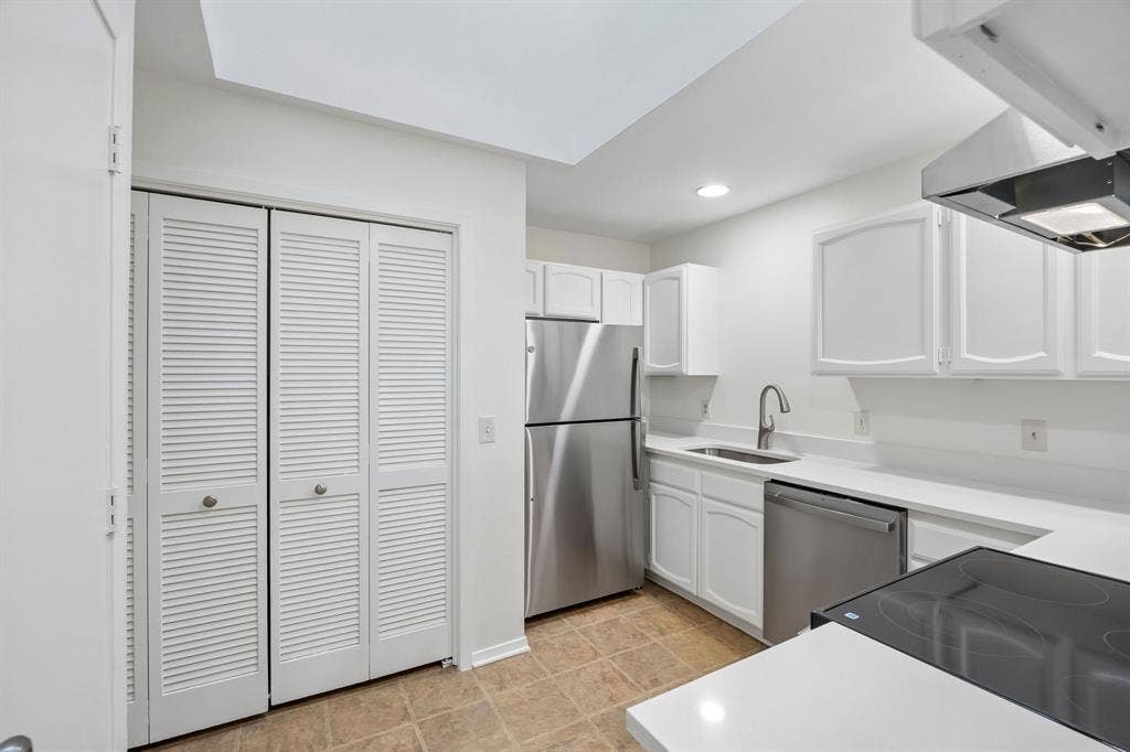 1613 19th Street, Plano, TX 75074 Kitchen featuring white cabinetry, stainless steel appliances, a flush-mount sink with a gooseneck faucet, quartz countertops, and tiled flooring
