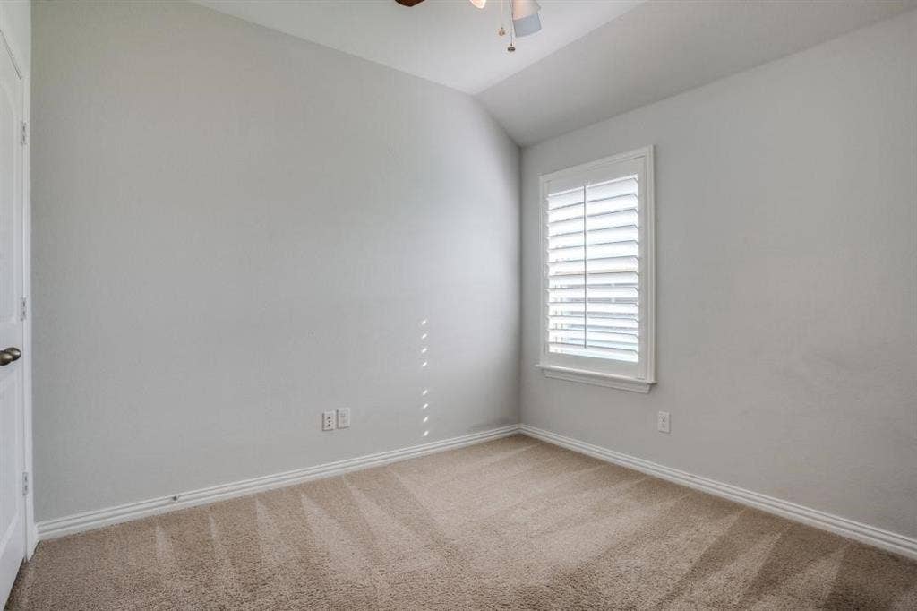 6229 Gloucester Drive, Celina, TX 76227 Window with plantation shutters, ceiling fan with light fixture, light-colored carpet, and painted walls