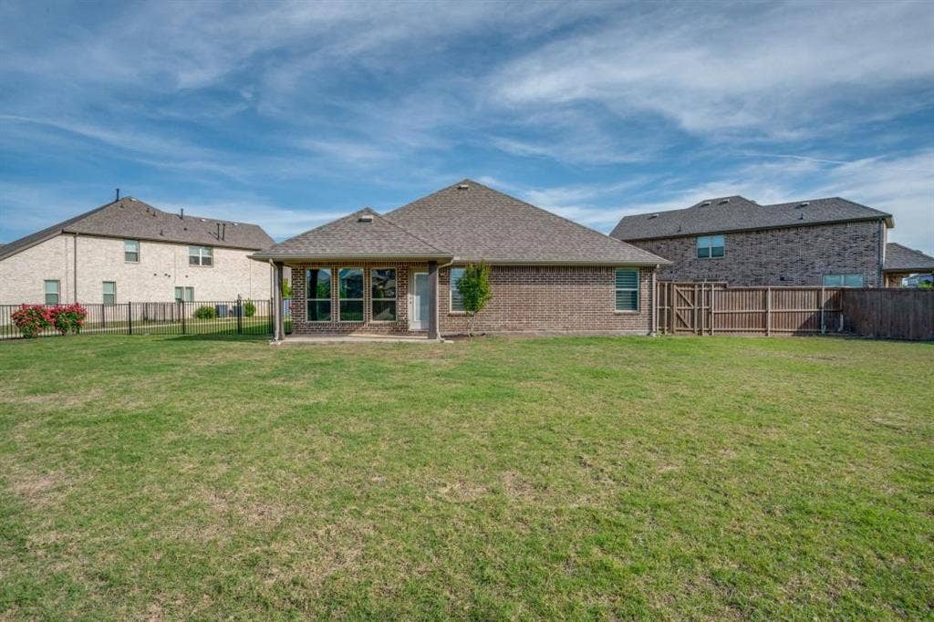 6229 Gloucester Drive, Celina, TX 76227 Expansive backyard featuring a brick exterior, covered patio, and large windows
