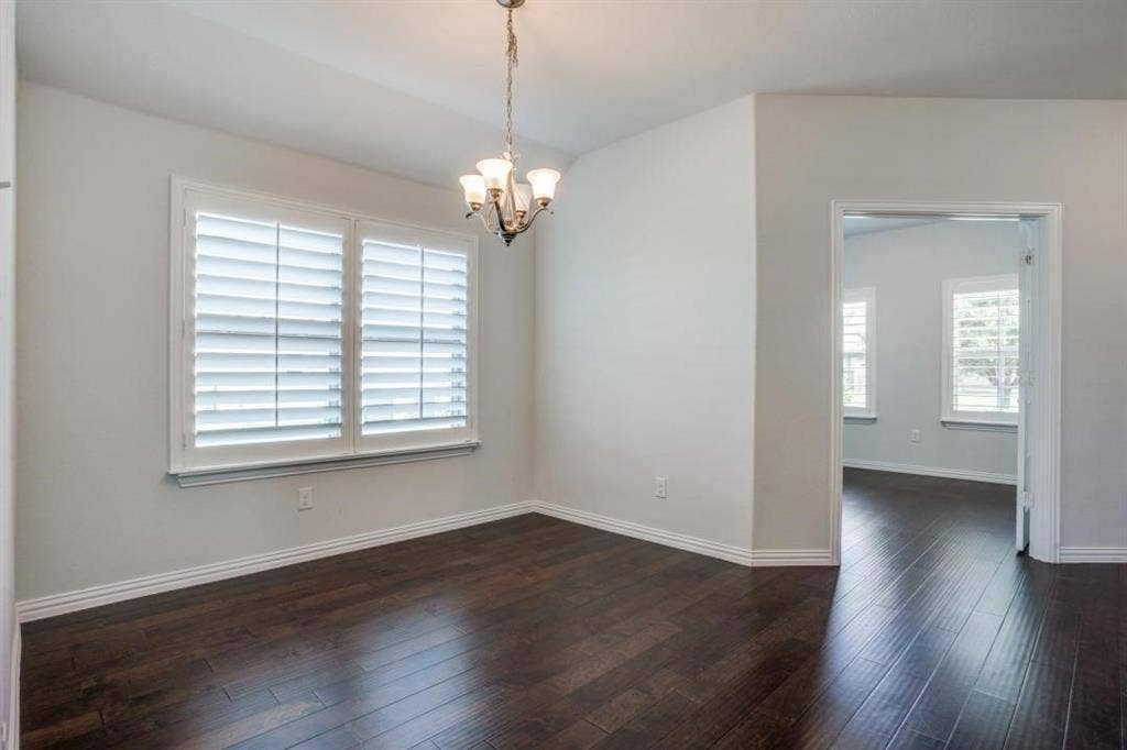 6229 Gloucester Drive, Celina, TX 76227 Hardwood-style flooring throughout, white plantation shutters, and a chandelier with glass shades