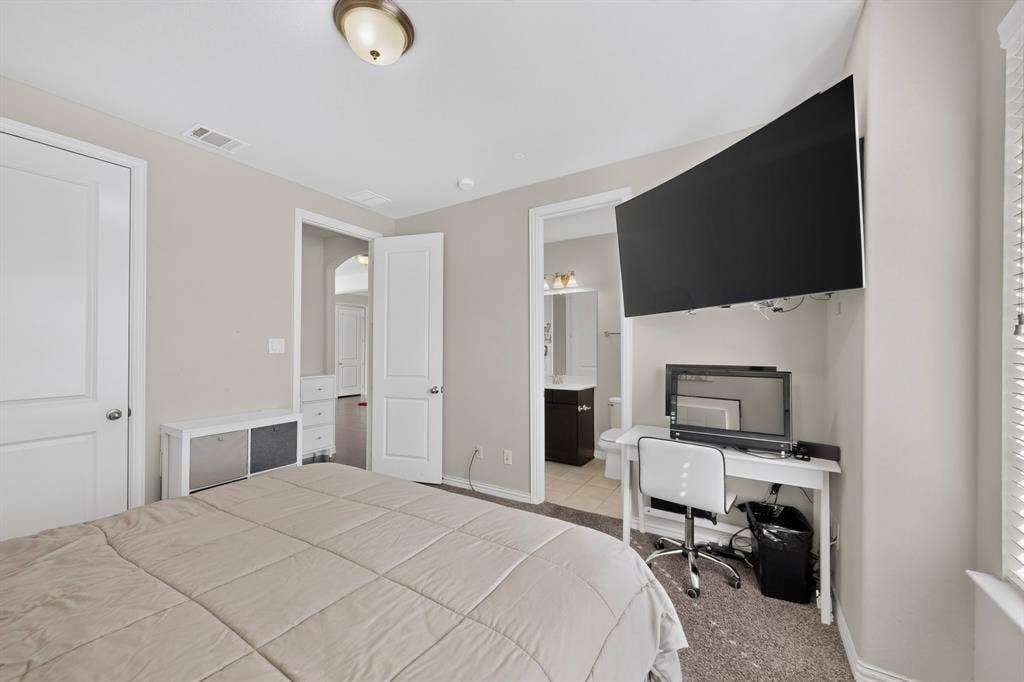 Recessed lighting, wall-mounted television, neutral wall color, carpet flooring, and white trim molding