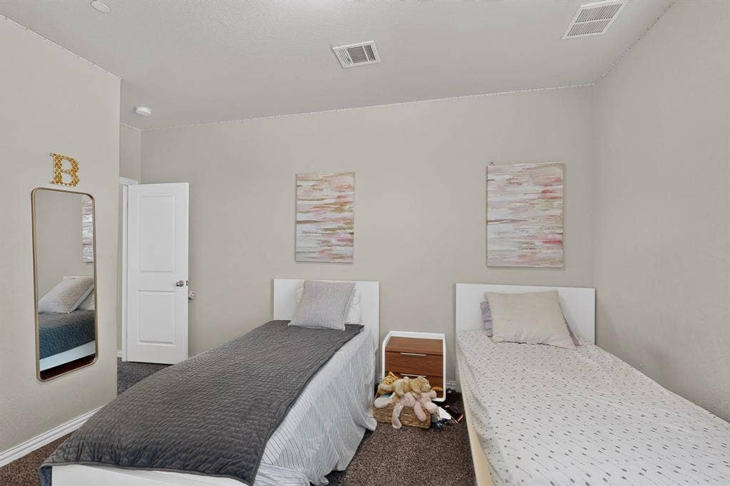 Neutral wall paint with textured carpet flooring and white interior doors