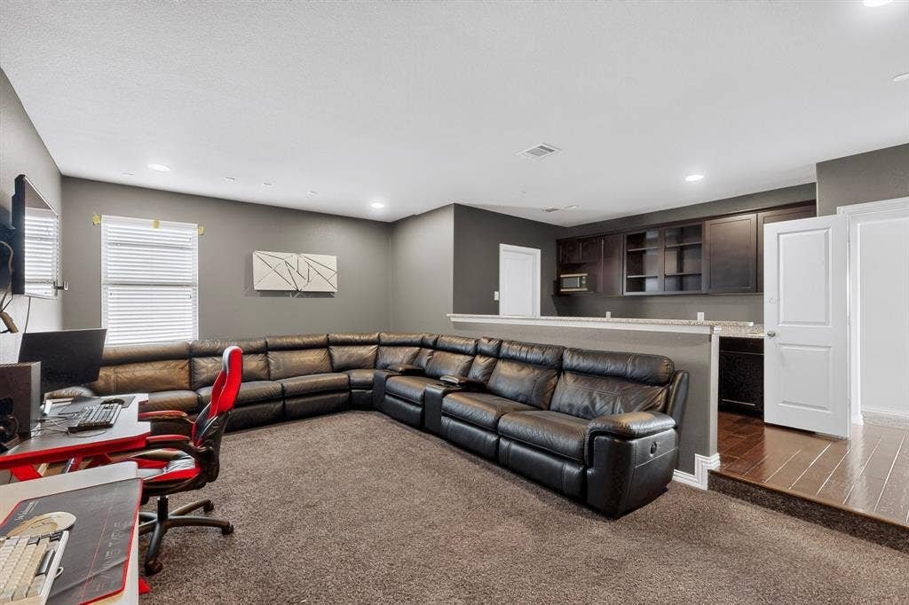 split level media room with serving bar and wetbar