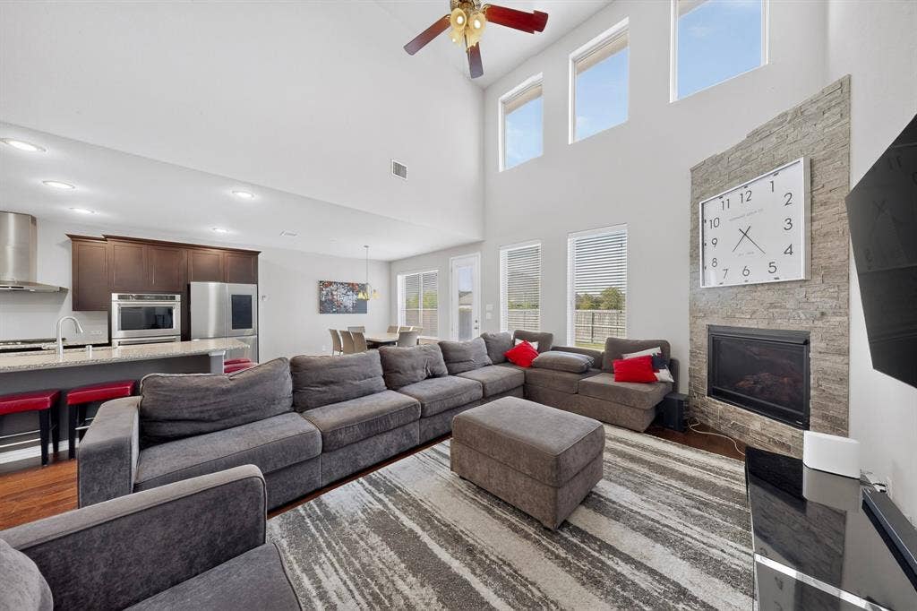 Open-concept living area with soaring ceilings and recessed lighting