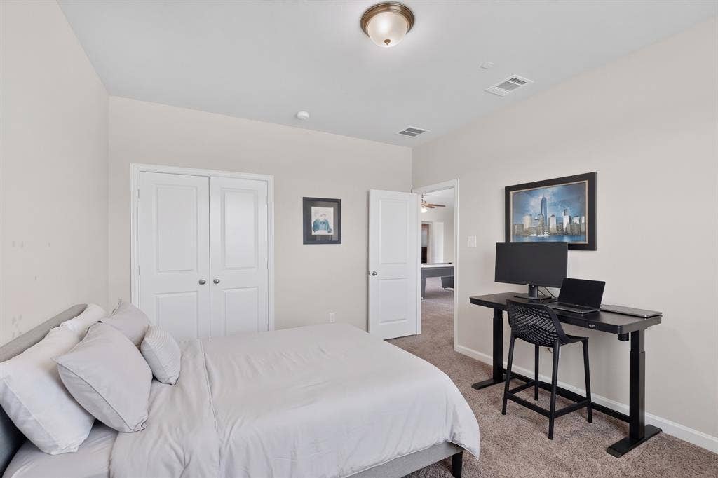 Neutral wall color, carpeted flooring, and a flush-mount ceiling light