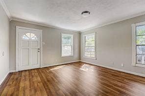 7729 Hillard Drive, Dallas, TX 75217 Wood-finish flooring, light gray walls, white trim, multiple windows, and a ceiling-mounted light fixture