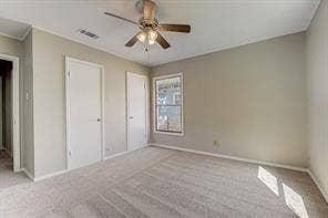 7729 Hillard Drive, Dallas, TX 75217 Recessed ceiling fan with integrated lighting, window with white trim, two white doors with dark hardware, and light-colored carpeting