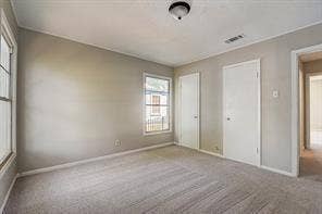 7729 Hillard Drive, Dallas, TX 75217 Neutral-toned walls complement plush carpeting