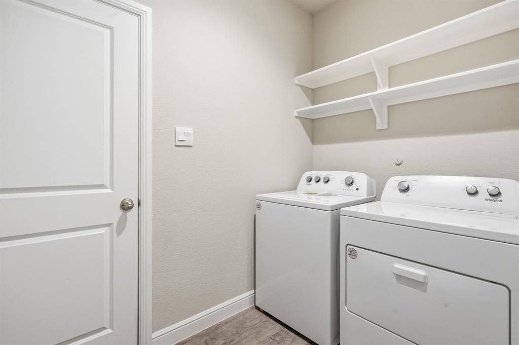 Appliances Stay. Utility room leads to garage and hallway - (virtually staged)