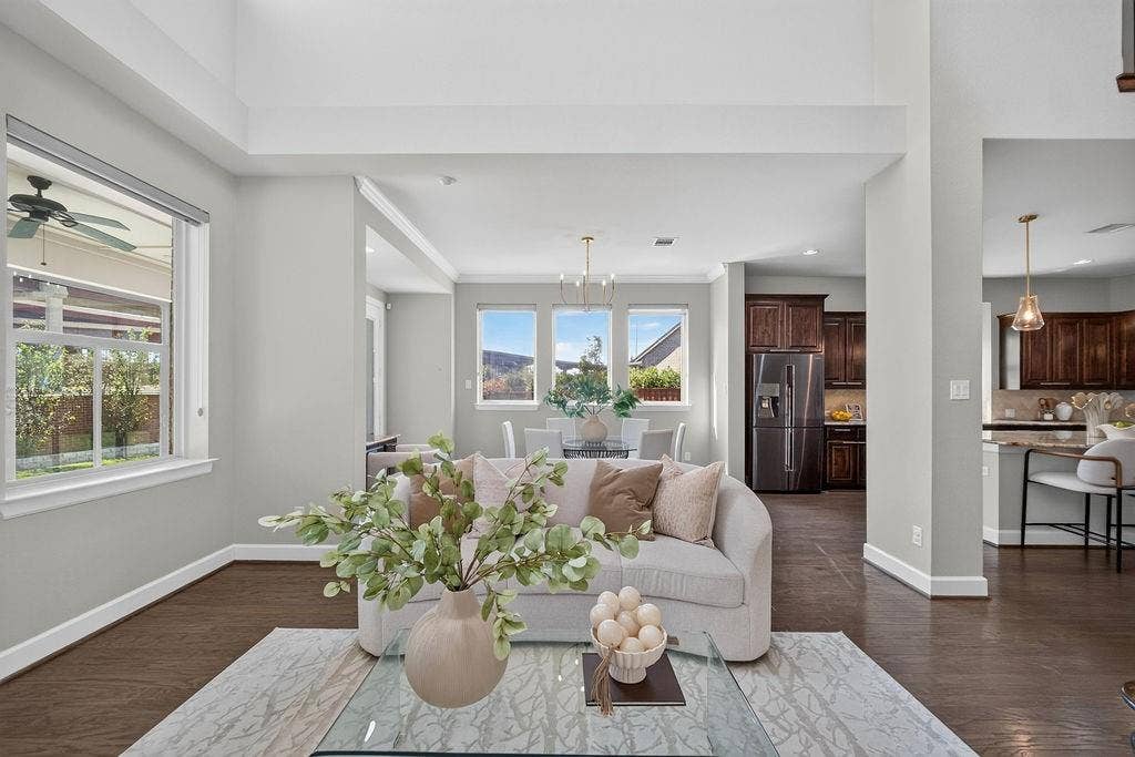 High ceilings, wood-finish flooring, multi-pane windows, and dark-finish cabinetry