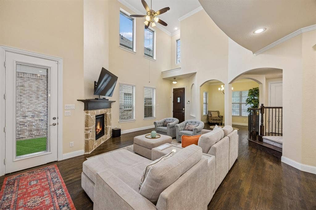 Living room with hand scraped hardwood floors and view of dining room and front door