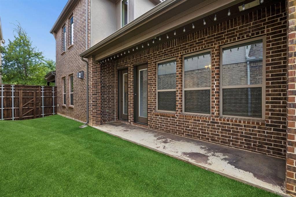 Side yard with turf and covered patio