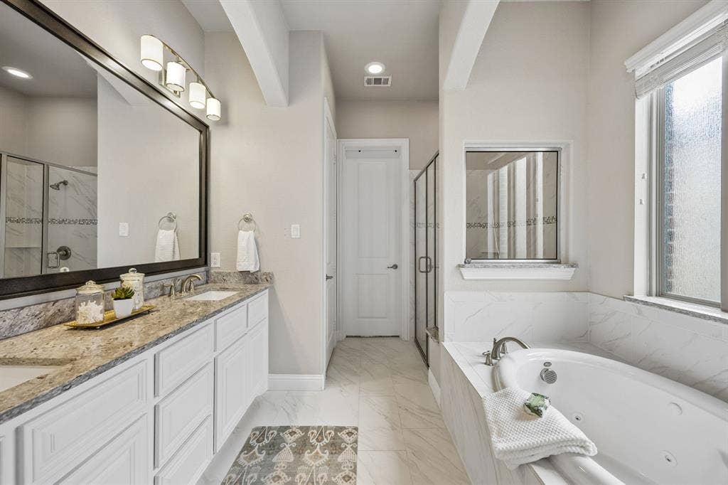 Primary bathroom with double sinks, granite, garden tub and large shower