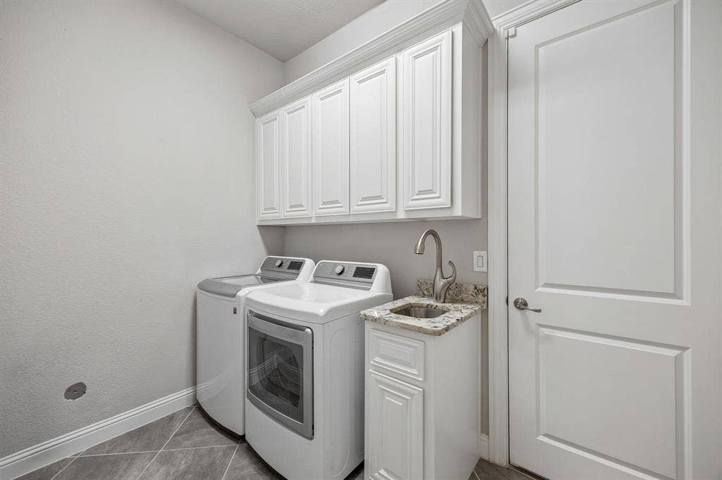 Laundry room with cabinets and sink
