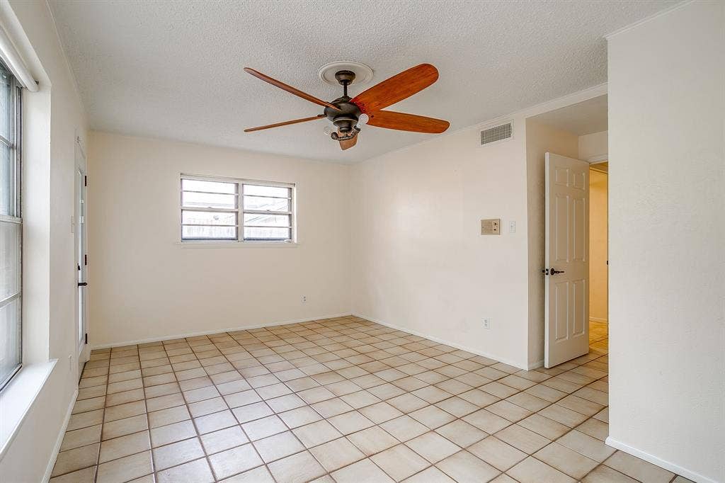 Neutral color palette with tile flooring and a ceiling fan