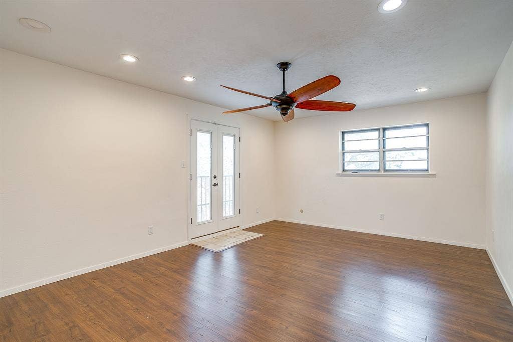 Wood-finish flooring, recessed lighting, and a ceiling fan with wood-tone blades