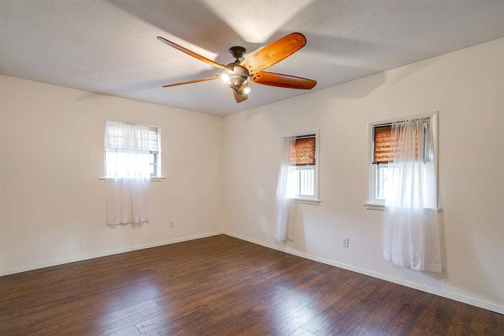Wood-finish flooring with a ceiling fan light fixture