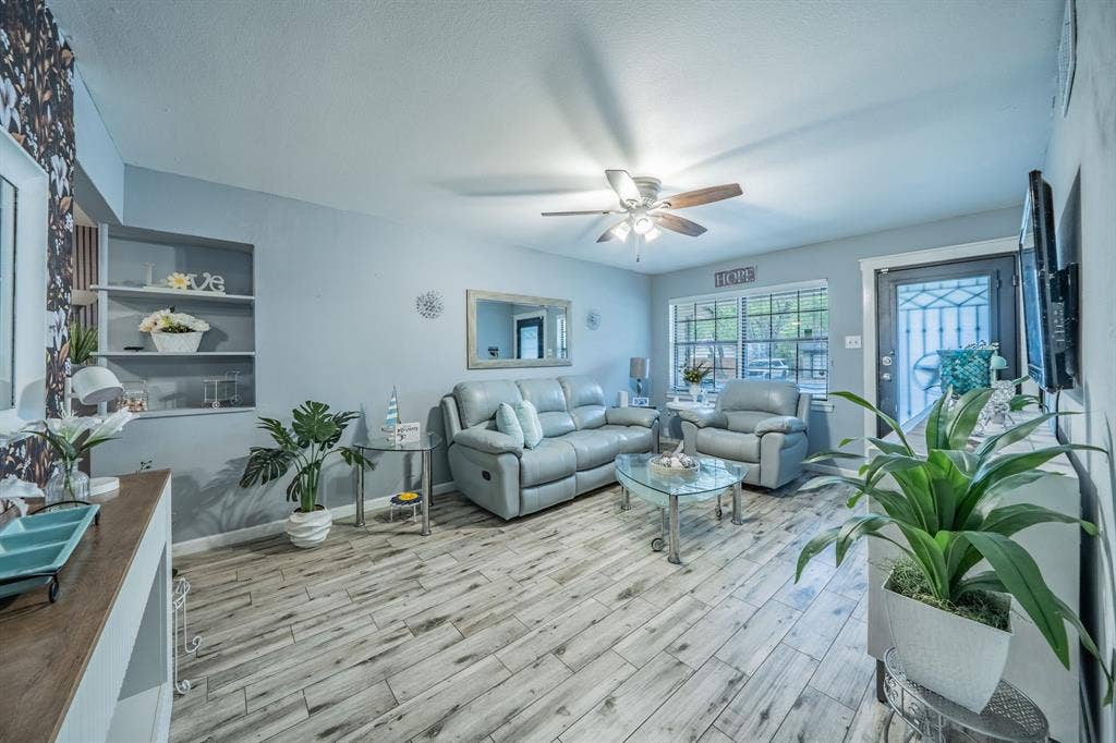 1938 Balla Way, Grand Prairie, TX 75051 Recessed built-in shelving, wood-finish flooring, ceiling fan with integrated lighting, window with grid pattern, and a security screen door