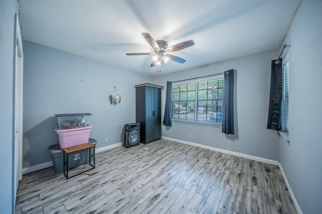 1938 Balla Way, Grand Prairie, TX 75051 Recessed window with blinds, ceiling fan with light fixture, wood-finish flooring, and light-toned walls