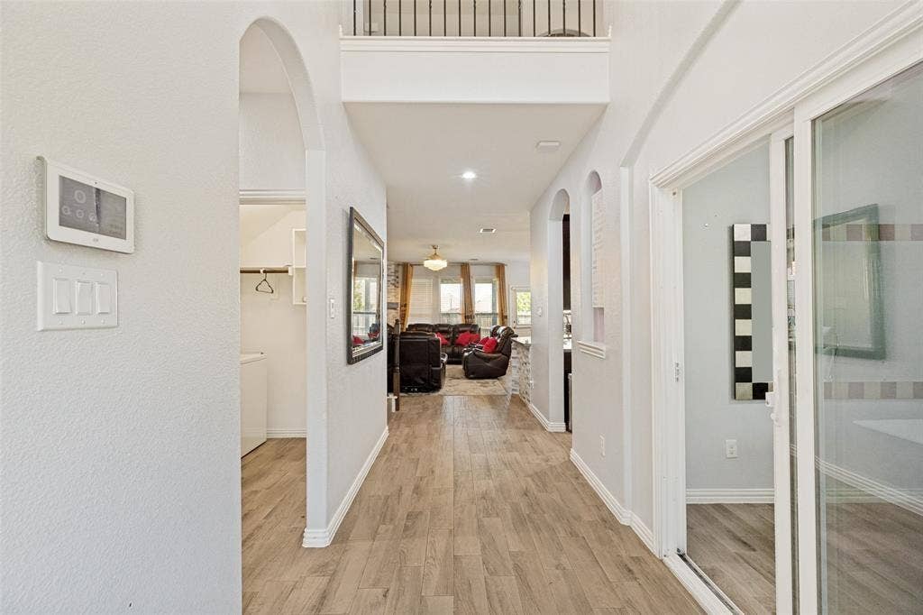 818 Black Hawk Drive, Princeton, TX 75407 Hallway with wood-finish flooring, arched doorways, and recessed lighting