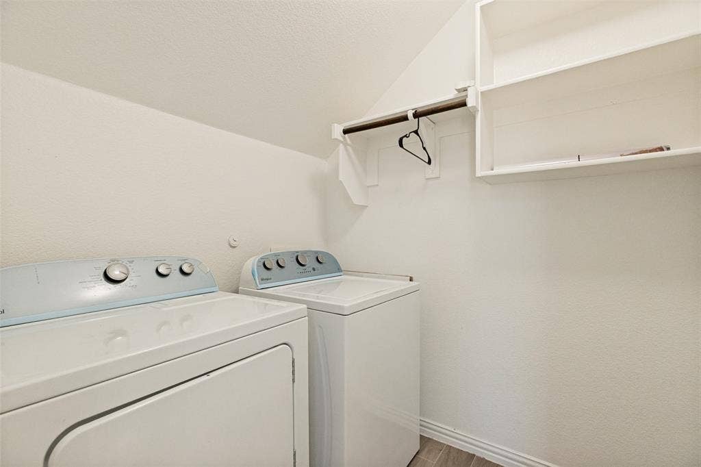 818 Black Hawk Drive, Princeton, TX 75407 Laundry area featuring wood-finish flooring, built-in shelving, and a hanging rod