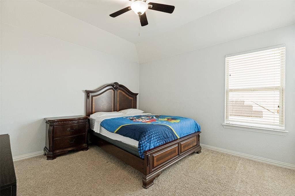 818 Black Hawk Drive, Princeton, TX 75407 Carpeting, vaulted ceiling, and ceiling fan with integrated lighting