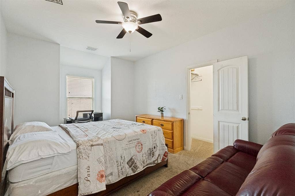 818 Black Hawk Drive, Princeton, TX 75407 Recessed window with blinds, ceiling fan with integrated lighting, built-in closet with an arched panel door, and carpet flooring