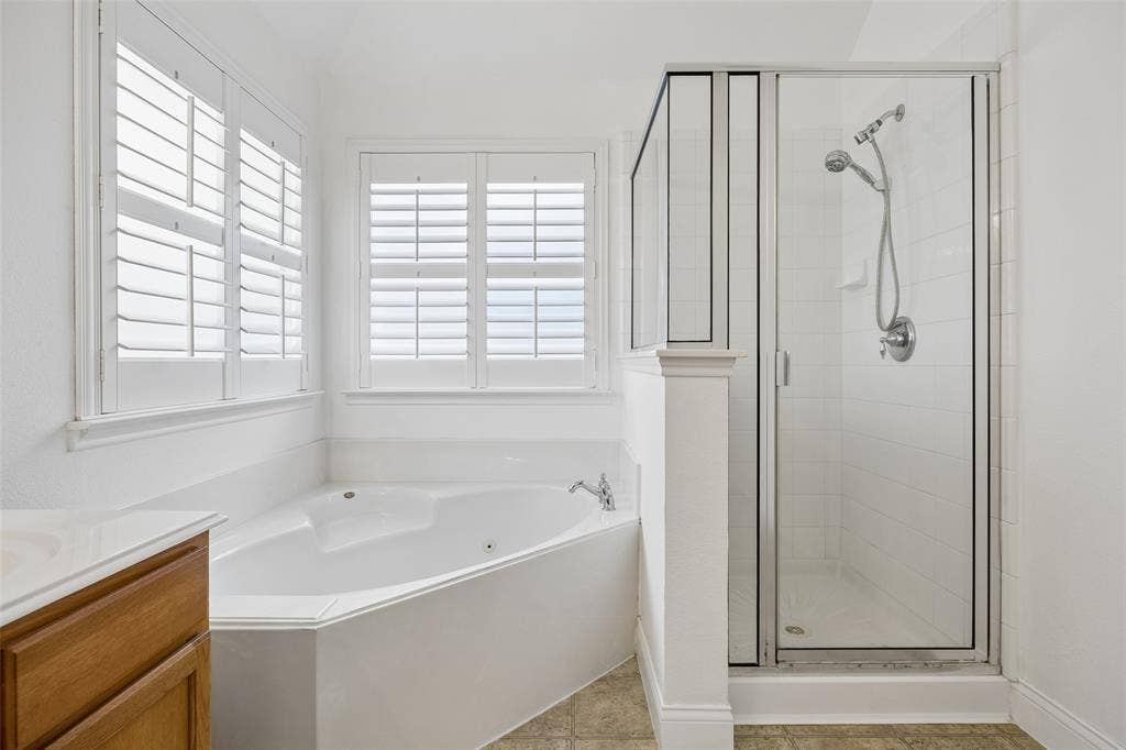 9828 Meadow Rue Drive, McKinney, TX 75072 Relax and unwind with a jetted soaking tub and separate shower.