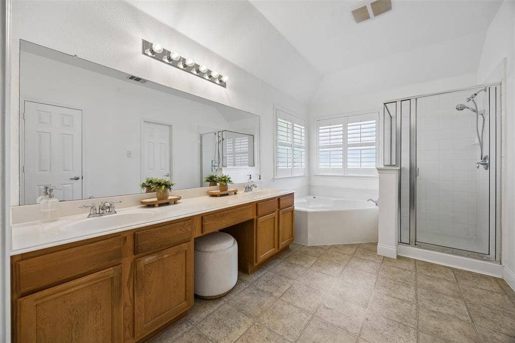 9828 Meadow Rue Drive, McKinney, TX 75072 Spacious primary bath with dual sinks, jetted soaking tub, separate shower and walk in closet.