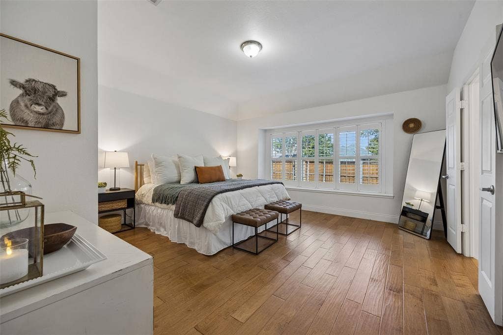 9828 Meadow Rue Drive, McKinney, TX 75072 Peaceful primary suite with warm flooring, a vaulted ceiling and plenty of natural light.