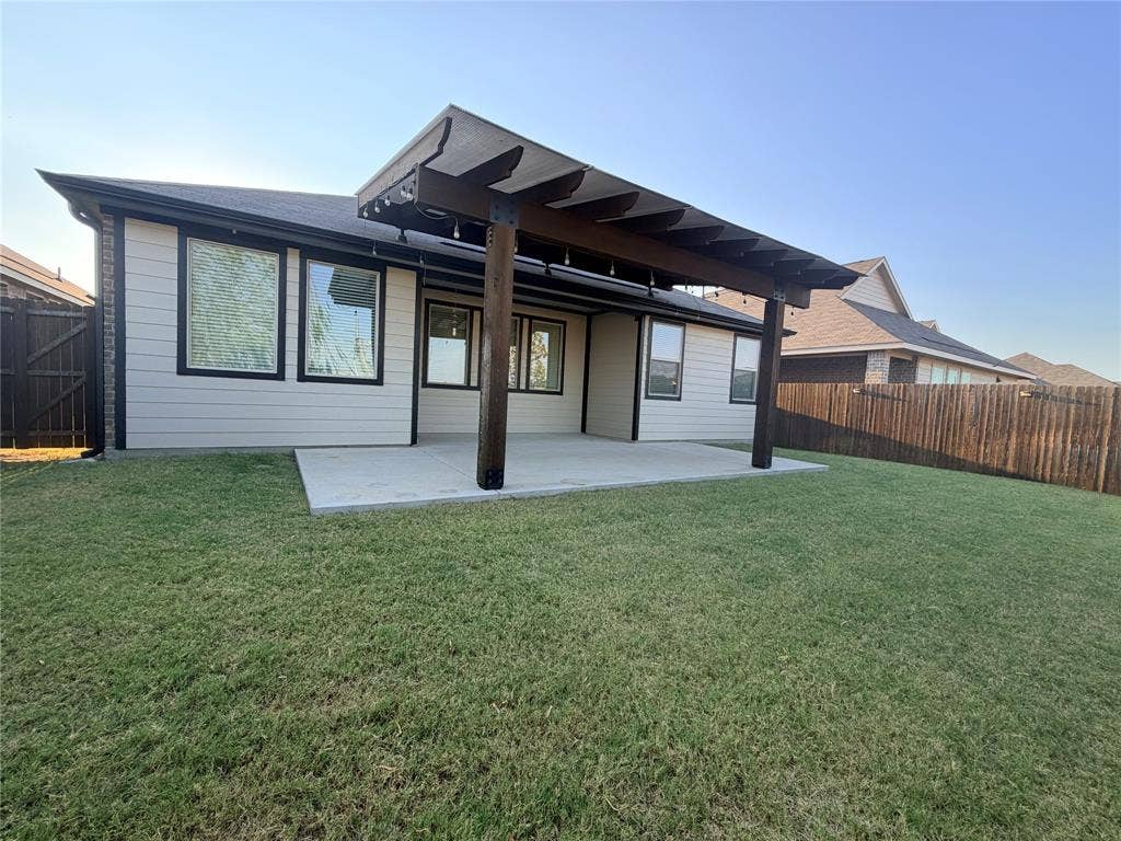 3308 Chasemoor Drive, Denton, TX 76207 Expansive backyard featuring a concrete patio, wood-frame covered pergola, and privacy fencing