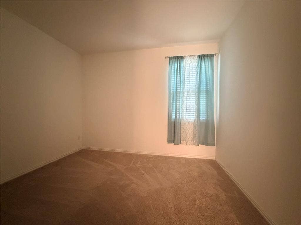 3308 Chasemoor Drive, Denton, TX 76207 Neutral wall colors, neutral carpeting, and a single window