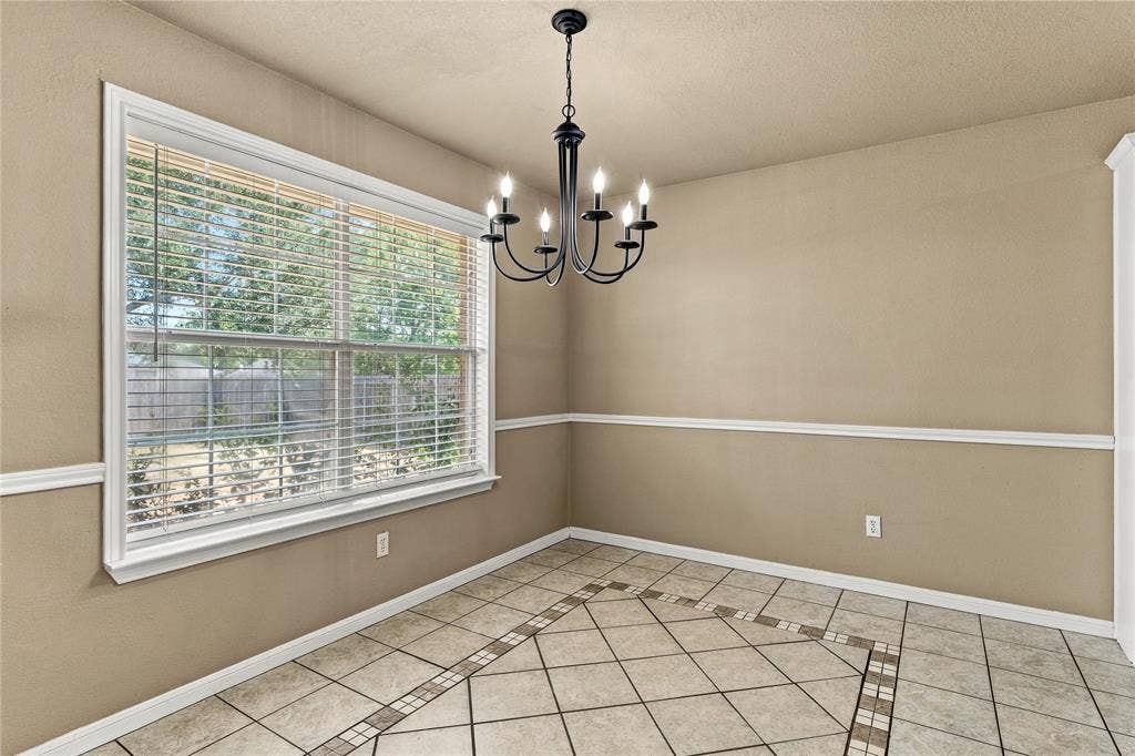 624 Willow Creek Drive, Hewitt, TX 76643 Tile flooring with a decorative inlay pattern, white trim, and a multi-pane window