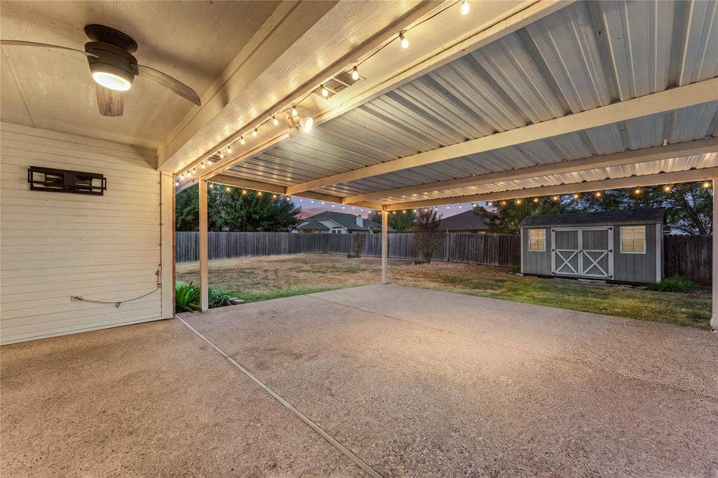 624 Willow Creek Drive, Hewitt, TX 76643 Expansive covered patio with concrete flooring, string lighting, and a ceiling fan