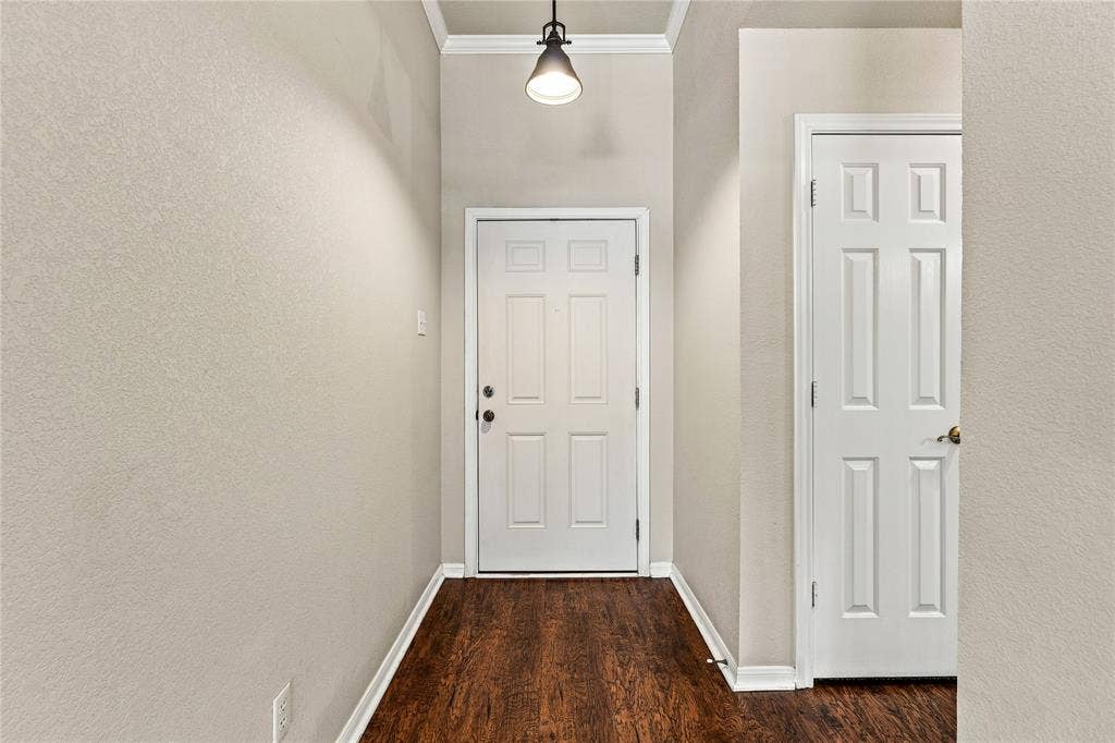 624 Willow Creek Drive, Hewitt, TX 76643 Wood-finish flooring, white panel doors, overhead pendant lighting, and crisp white trim
