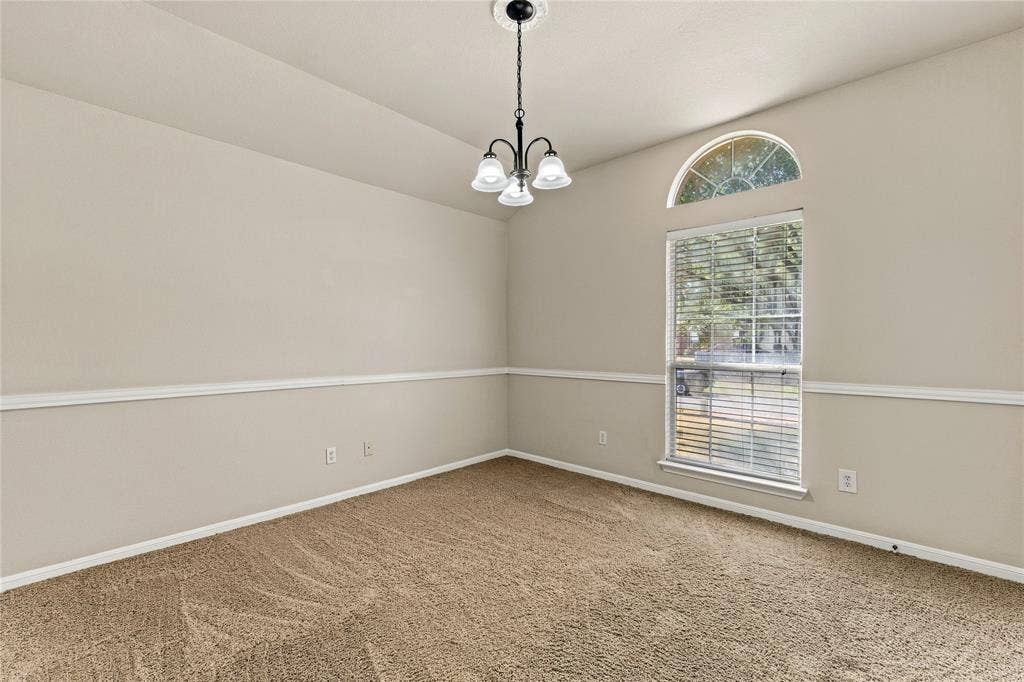 624 Willow Creek Drive, Hewitt, TX 76643 Room featuring textured carpeting, a window with an arched transom, and a contemporary pendant light fixture