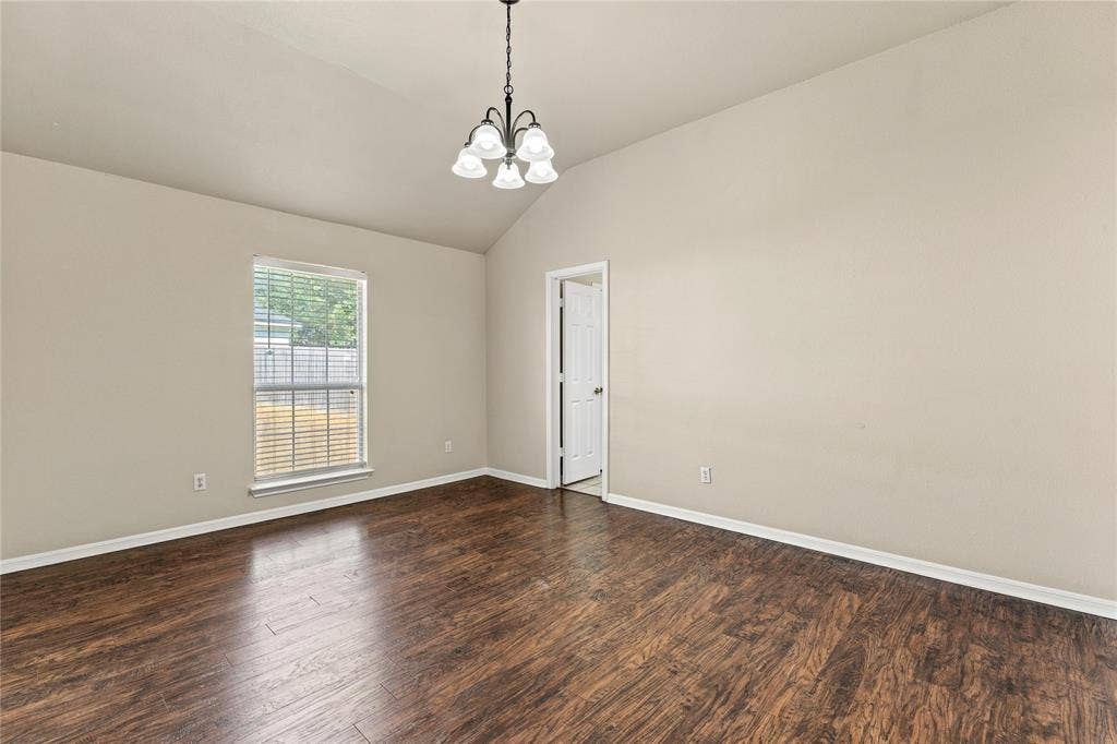 624 Willow Creek Drive, Hewitt, TX 76643 Vaulted ceiling, wood-finish flooring, window with blinds, chandelier, painted walls