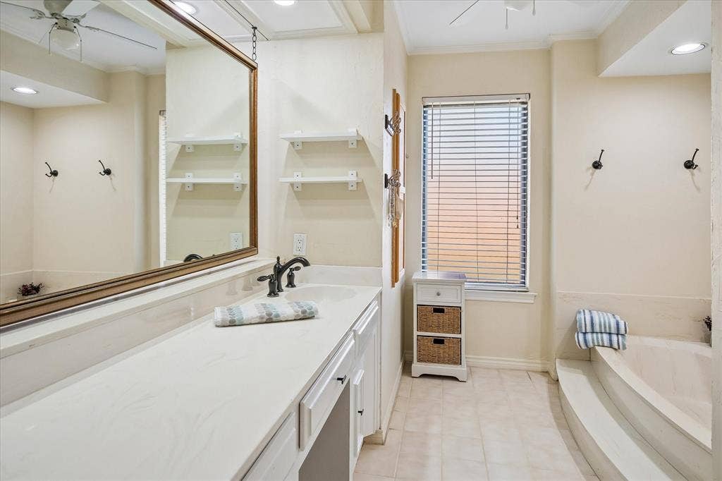 7603 Queens Ferry Lane, Dallas, TX 75248 Double vanity with integrated sink, rectangular window, built-in bathtub, and recessed lighting