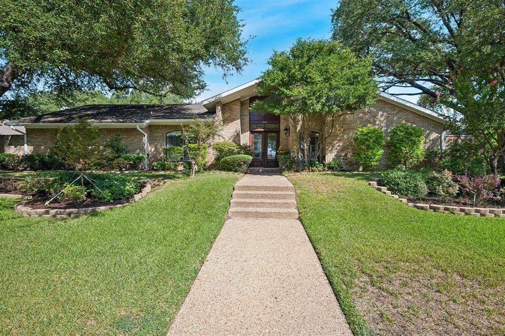 7603 Queens Ferry Lane, Dallas, TX 75248 Brick exterior with a gabled roof and mature trees