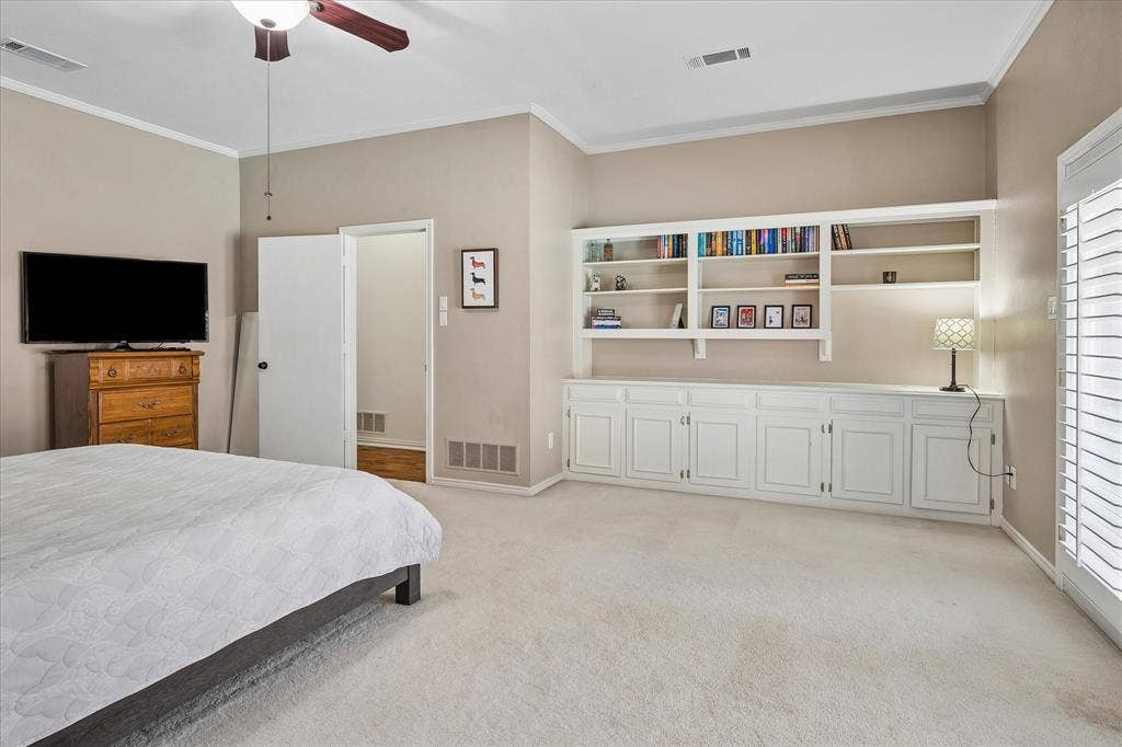 7603 Queens Ferry Lane, Dallas, TX 75248 Built-in cabinetry with open shelving, ceiling fan, crown molding, and plantation shutters