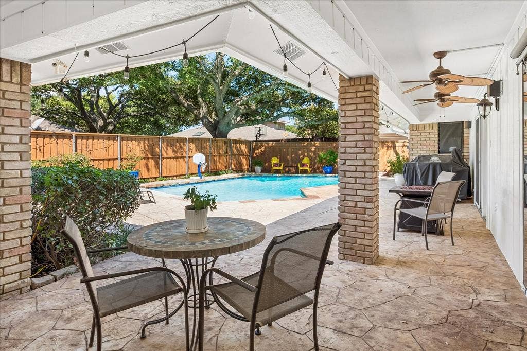 7603 Queens Ferry Lane, Dallas, TX 75248 Covered patio with stamped concrete flooring and ceiling fans