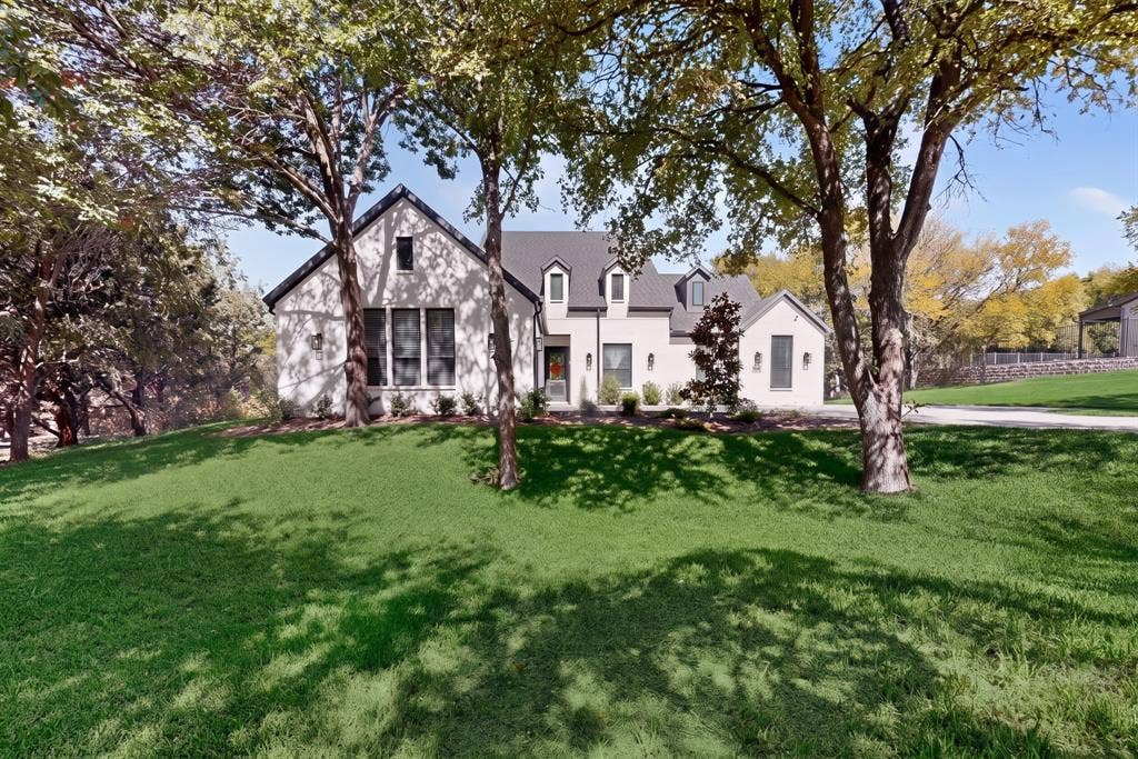 2519 Tamaron Cove, Cedar Hill, TX 75104 White exterior with dark trim accents, dormer windows, a covered entry, established trees, and a concrete driveway
