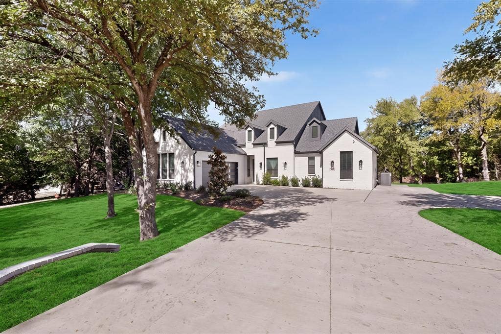 2519 Tamaron Cove, Cedar Hill, TX 75104 White painted brick exterior with dark gray roofing, multiple dormer windows, and a concrete driveway