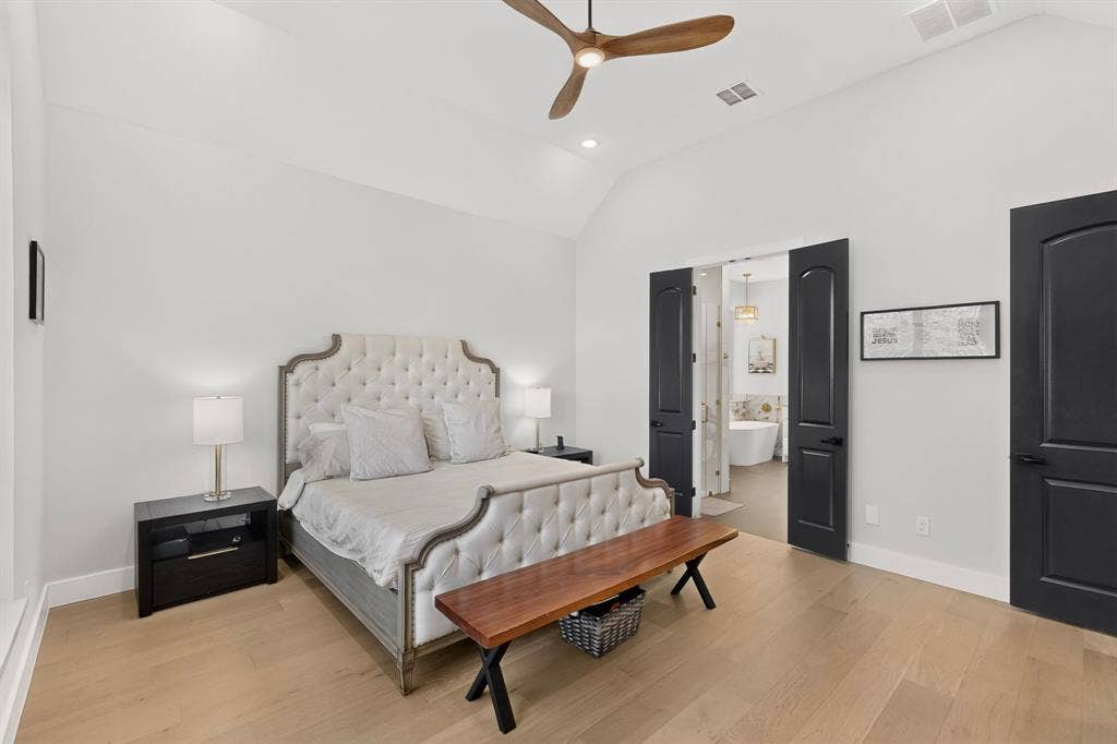 2519 Tamaron Cove, Cedar Hill, TX 75104 Vaulted ceiling, ceiling fan, natural wood-finish flooring, black interior doors, and a bathroom with a freestanding tub