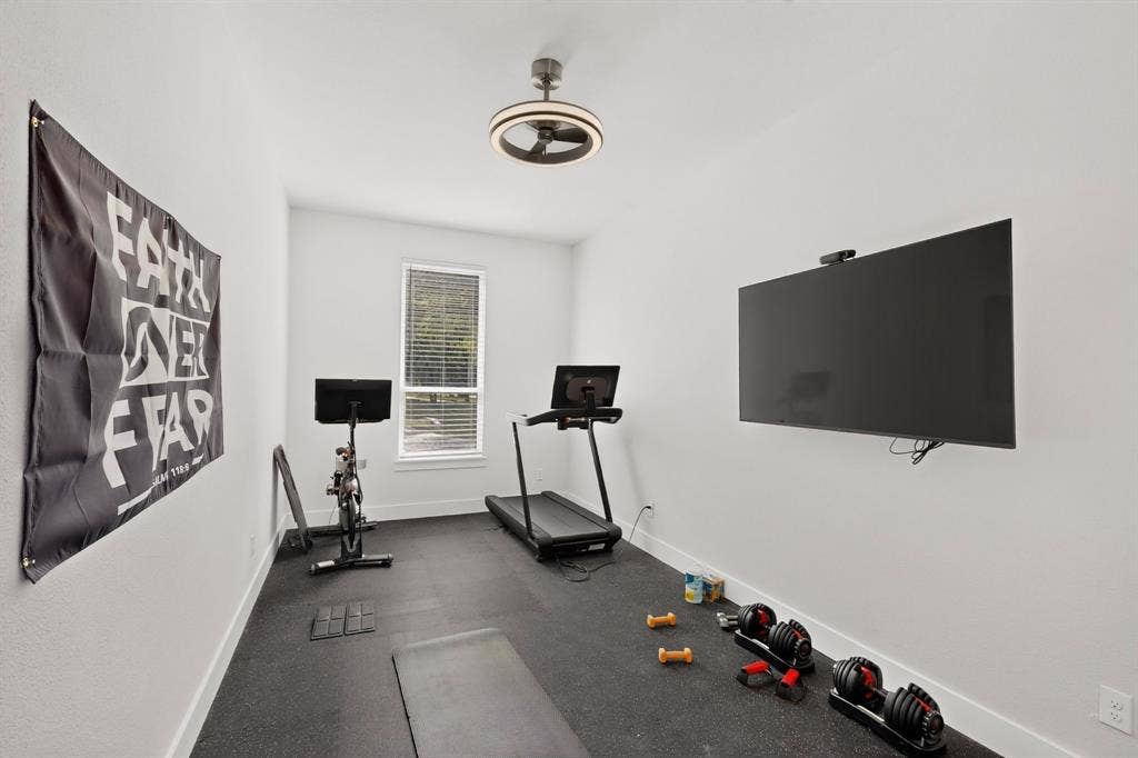 2519 Tamaron Cove, Cedar Hill, TX 75104 Dedicated fitness space with resilient rubber flooring, a single window with blinds, and a contemporary ceiling light fixture
