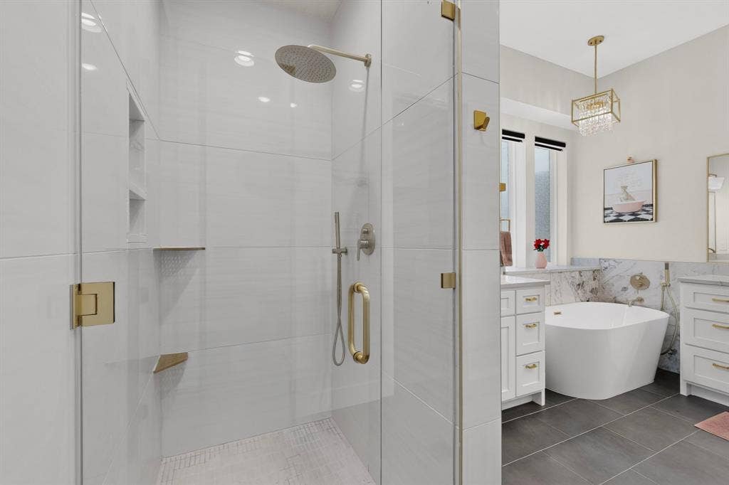 2519 Tamaron Cove, Cedar Hill, TX 75104 Glass-enclosed shower with a rainfall showerhead and gold-tone fixtures